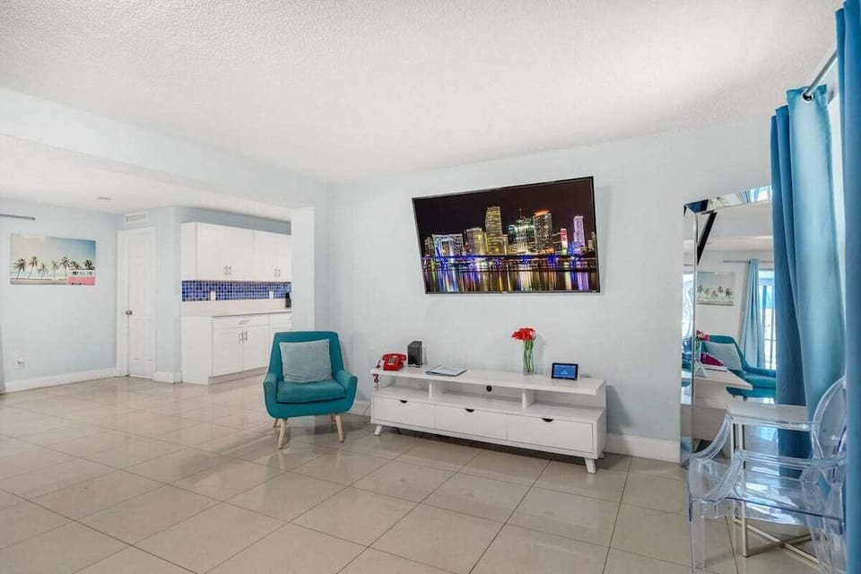 Kick back in this bright, modern living room with stylish seating, vibrant decor, and a smart TV. A welcoming Airbnb space for relaxing after a day of adventure.