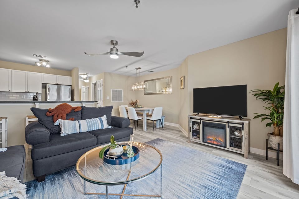 Bright and spacious living area with cozy seating, electric fireplace, and smart TV: perfect for relaxing after a day out