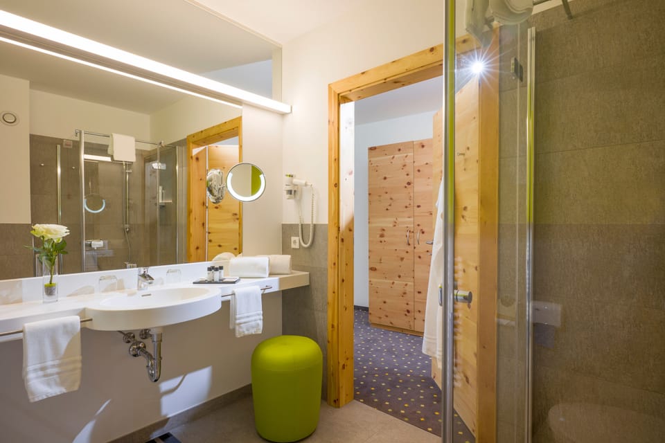 Shower, designer toiletries, hair dryer, bathrobes