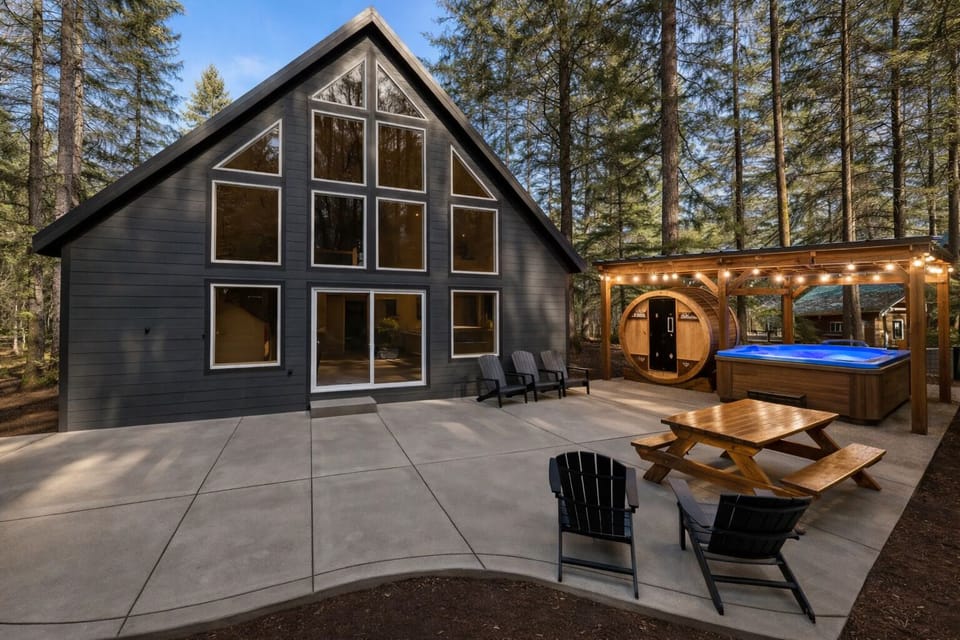 Beautiful A-frame cabin with glowing windows and forest privacy