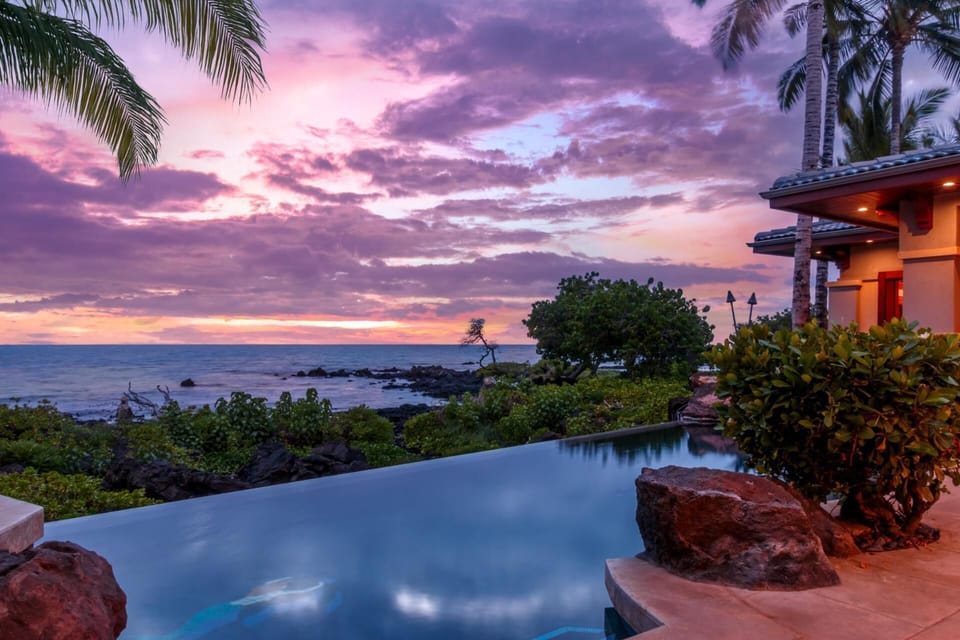 Swim in your private infinity-edge pool overlooking the ocean and surrounded by sunset skies.