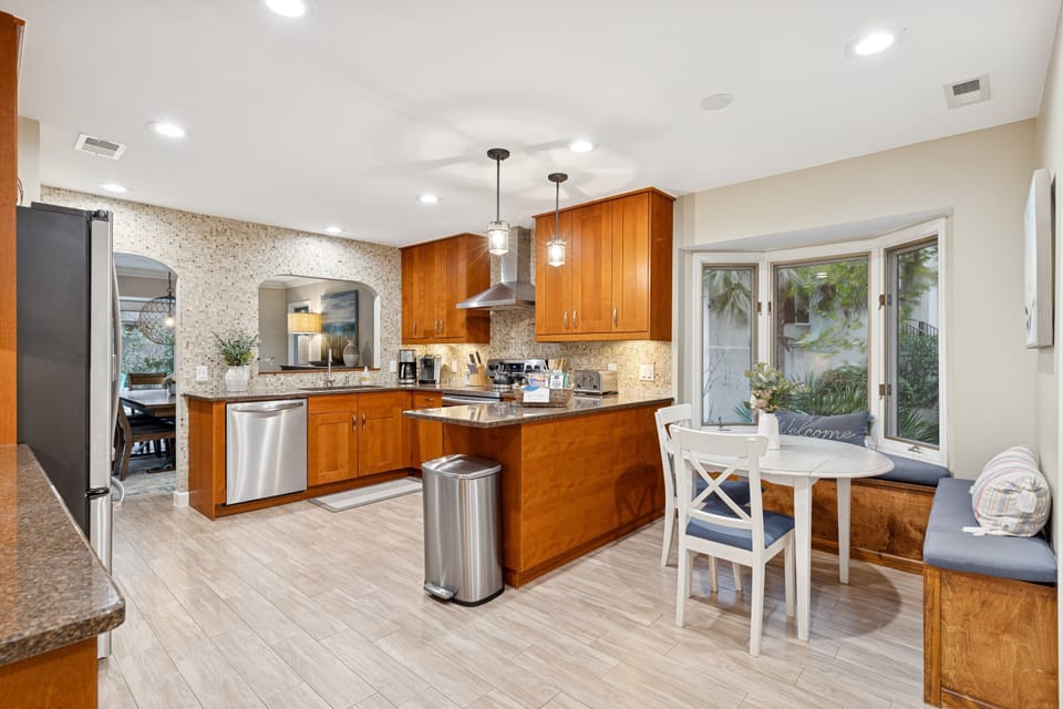 Fully equipped with modern appliances, a large fridge, and ample counter space