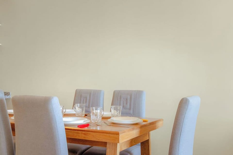 Fully equipped modern kitchen with stainless appliances and bar seating, ideal for cooking and gathering together.