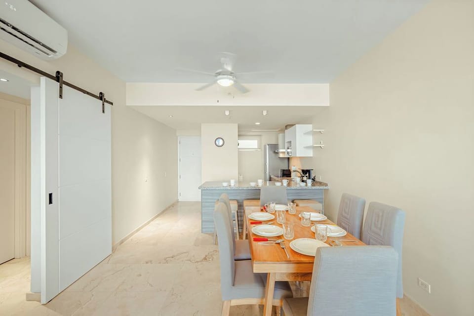 Fully equipped modern kitchen with stainless appliances and bar seating, ideal for cooking and gathering together.