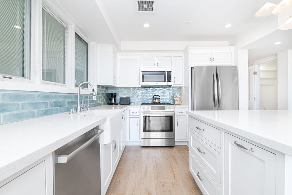 A beautifully renovated kitchen with sleek finishes and modern appliances, perfect for preparing any meal
                