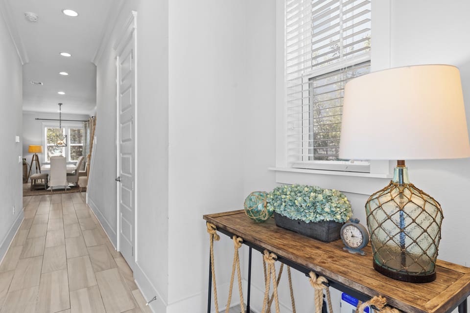 Entryway console table with mirror and coastal accents.
