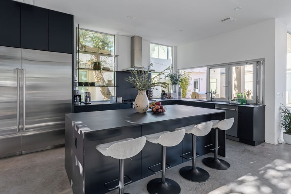 Unit 1304A: Sleek chef’s kitchen with oversized island, open shelving, and high-end appliances.