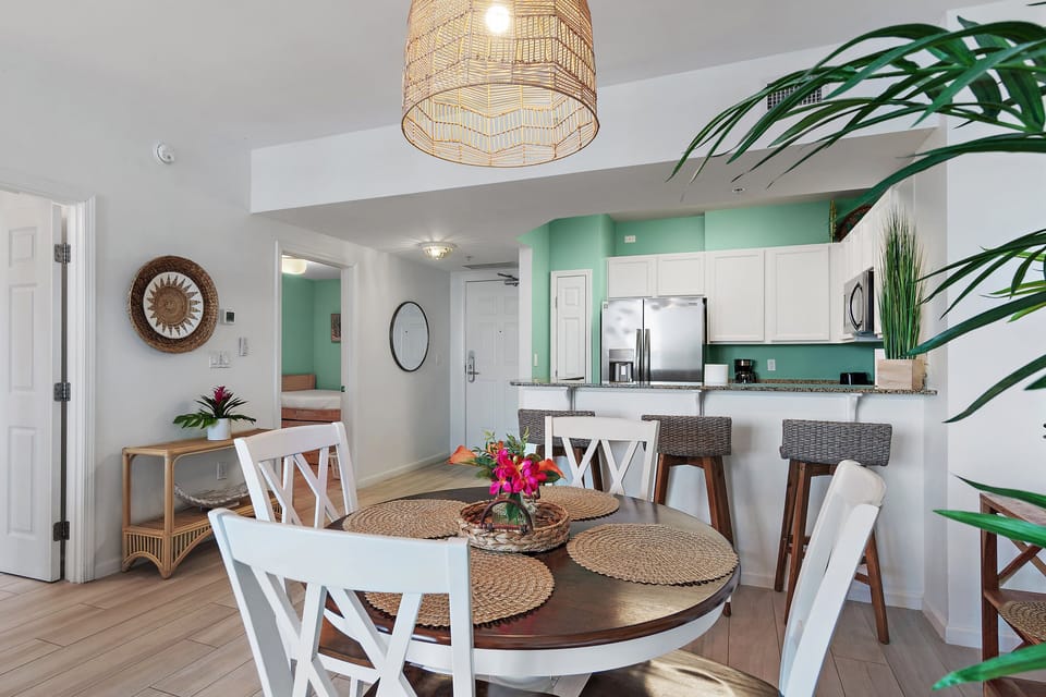Gather around this charming dining table for delicious meals and lively conversation, or enjoy a quick bite at the breakfast bar in your well-appointed kitchen.