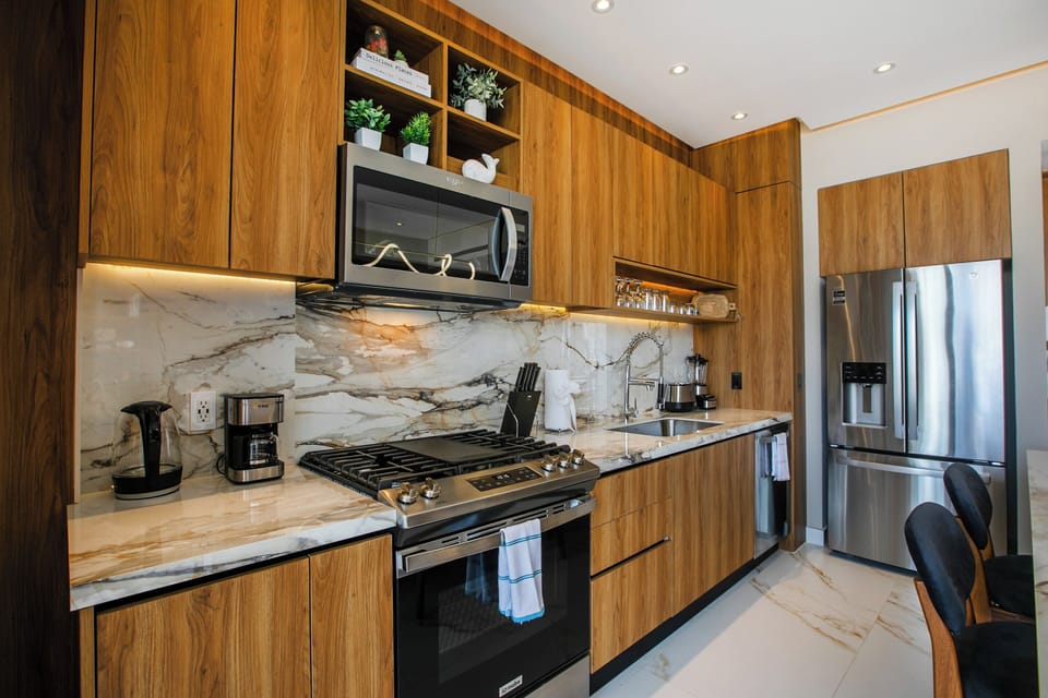 Sleek kitchen with stainless-steel appliances and marble countertops