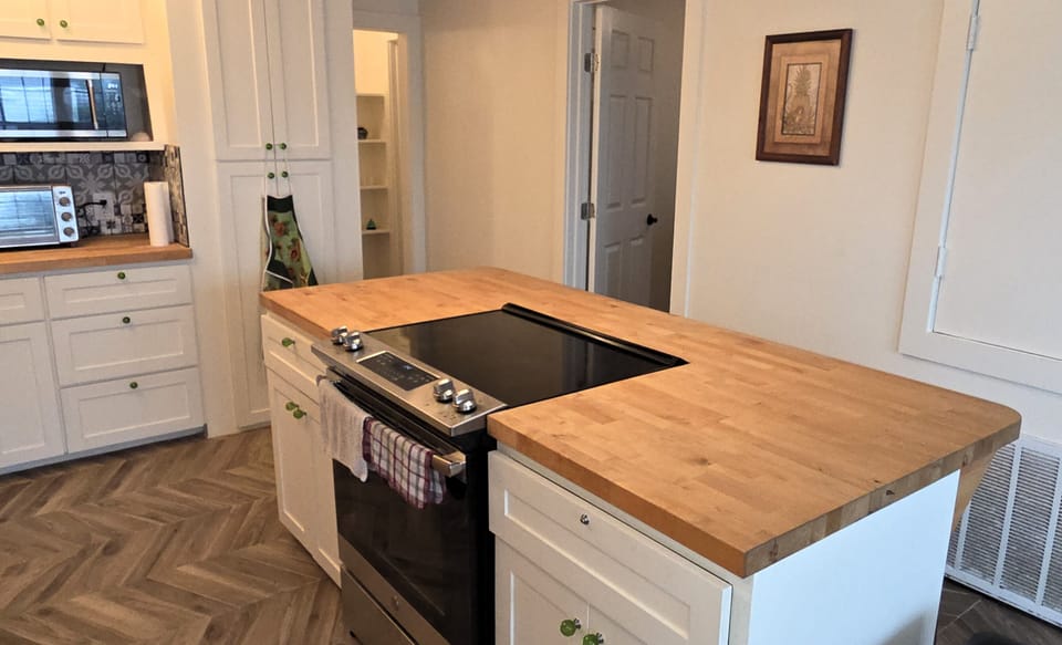 The kitchen has an island for prep work, storage, or additional seating.