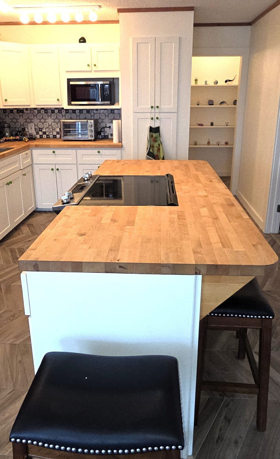 The kitchen island also serves as a breakfast bar.