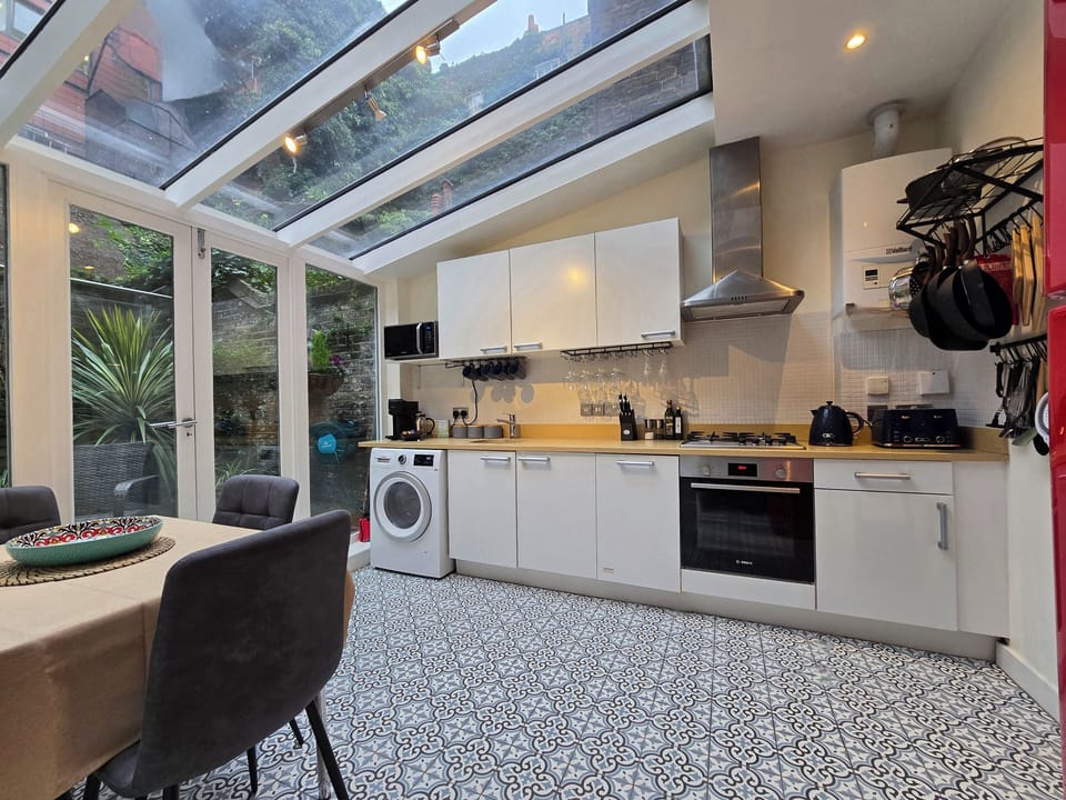 Bright natural light kitchen-diner, all appliances, opening onto a rare garden.