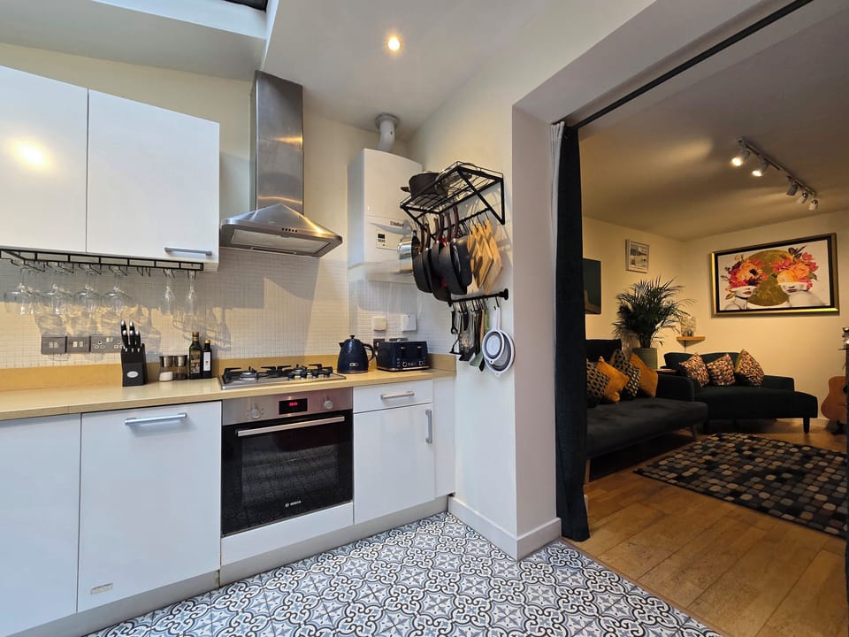 Living room opens onto large kitchen diner; blackout curtains for sofa bed