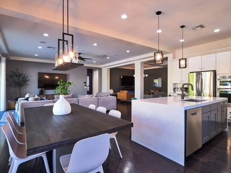 Family-style dining open to living room and lounge beyond -- the ideal setup for connected, but separate, family gatherings Where memories are made. 