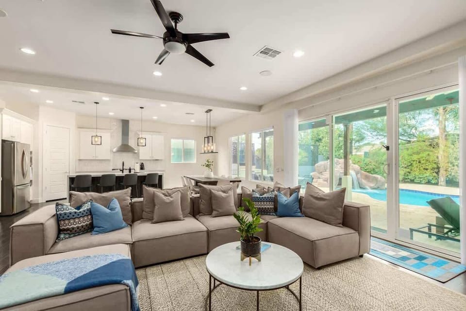 Living room/kitchen/dining provide an open view to the pool and lush backyard.