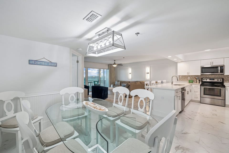Your bright, coastal-inspired space flows seamlessly from dining to kitchen, perfect for gathering with family and friends.