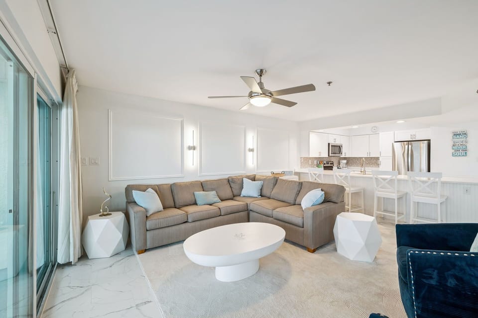 Sink into your spacious sectional sofa in this bright, modern living space where comfort meets coastal elegance.