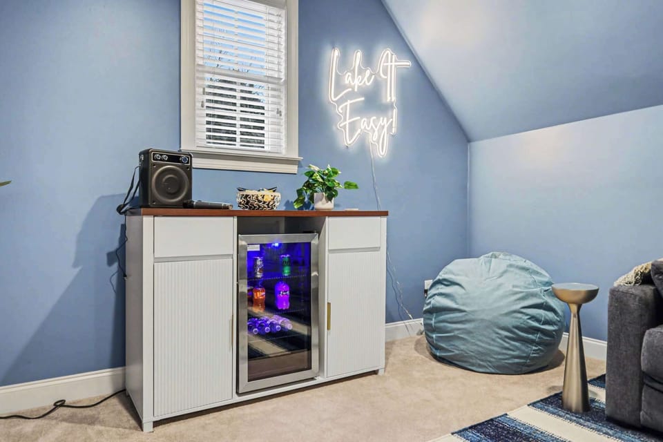 The second floor is a favorite gathering spot, featuring a media room with a 65" smart TV, bar area, board games, karaoke machine, and Infinity Game Table. A pullout sofa offers additional sleeping space, making it perfect for relaxation and fun.