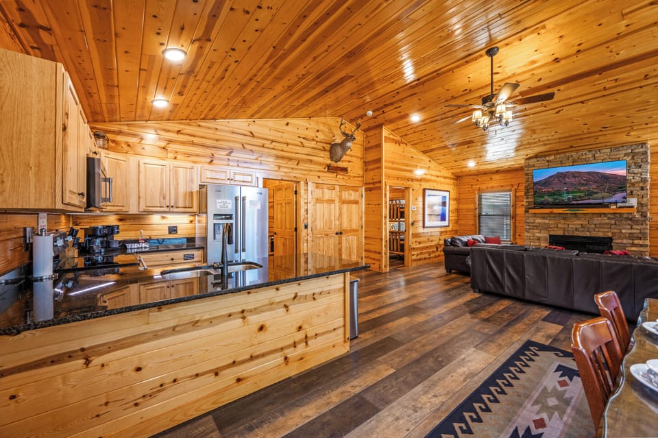 From the side door, the cabin opens to dining, kitchen left, living room ahead
