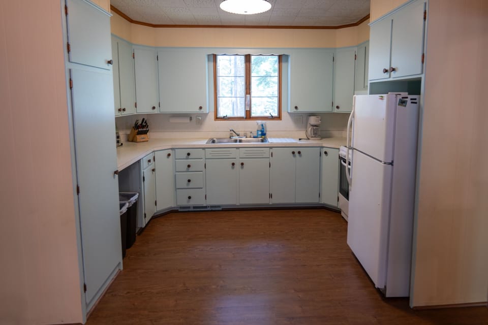 Kitchen with fridge, stove, oven, coffee maker and other essentials
