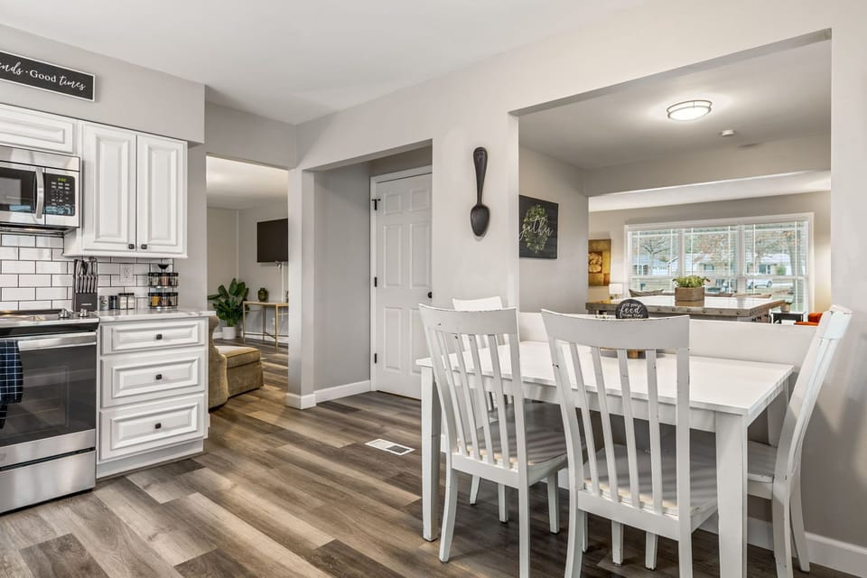 Bright dining area positioned beside the kitchen for convenient family meals.