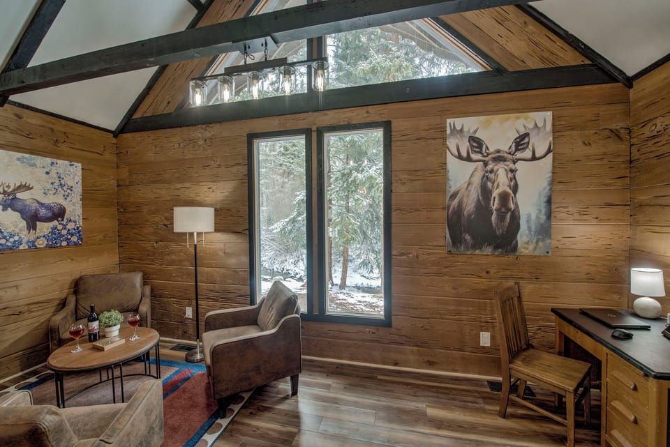 Relax in your light-filled retreat—vaulted ceilings, forest views, and cozy seating create a peaceful space for you to unwind and make it yours.