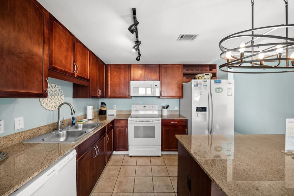 Fully equipped kitchen with spacious granite counters and plenty of cabinet storage