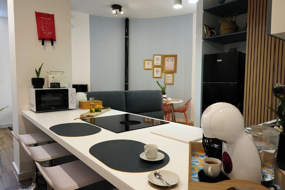 Clean and functional kitchen with breakfast bar and coffee setup.