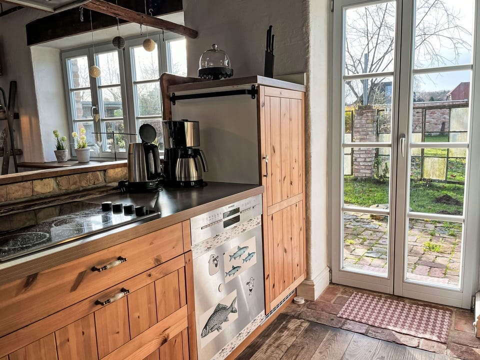 Kitchen, Wood, Kitchen Appliance, Cabinetry, Flooring, Countertop, Furniture, Major Appliance, Interior Design, Home Appliance