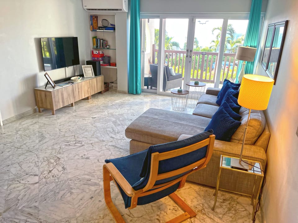 Bright living area with full AC and balcony access
