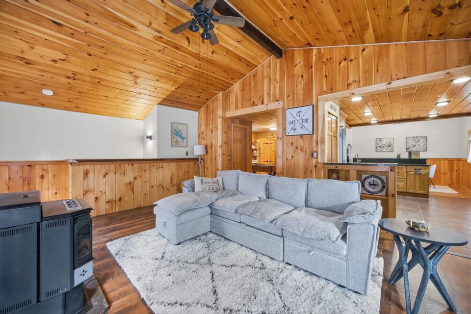 Open-concept living room with vaulted ceilings and cozy cabin charm.