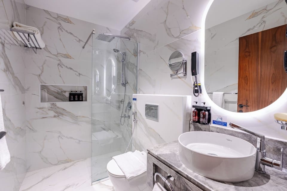 Shower, hair dryer, slippers, towels