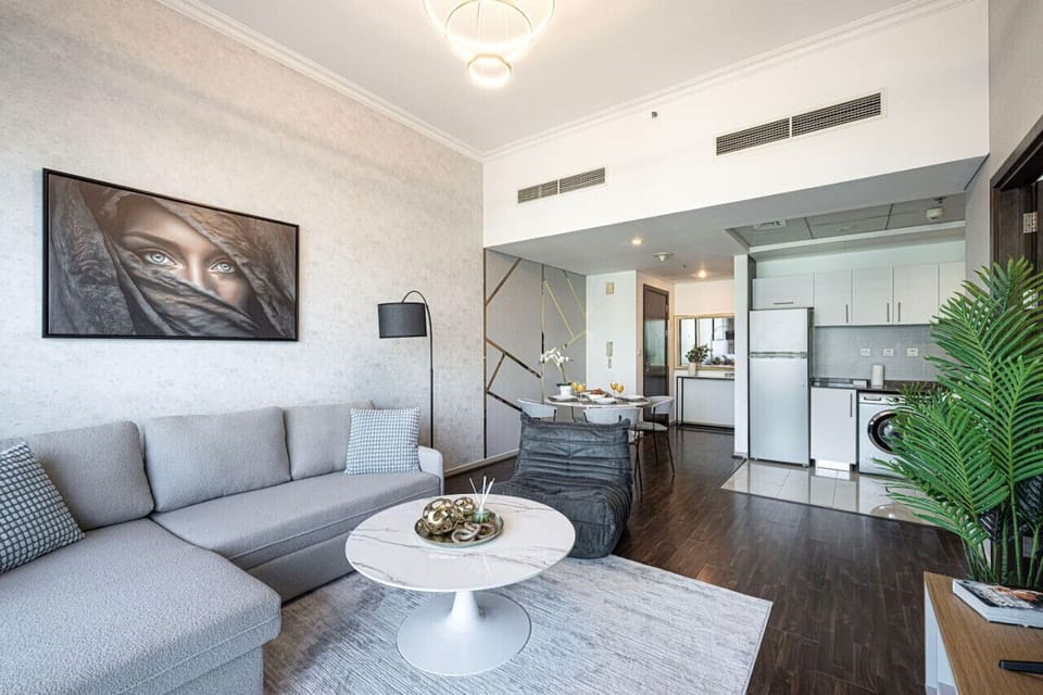 Feel at home and relax in the spacious living room with modern decor and floor-to-ceiling windows offering stunning views of Dubai Marina.