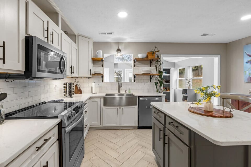 Fully stocked kitchen with multiple small appliances, cookware, bakeware, & spices