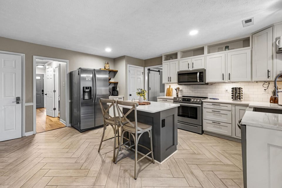 Fully stocked kitchen with multiple small appliances, cookware, bakeware, & spices