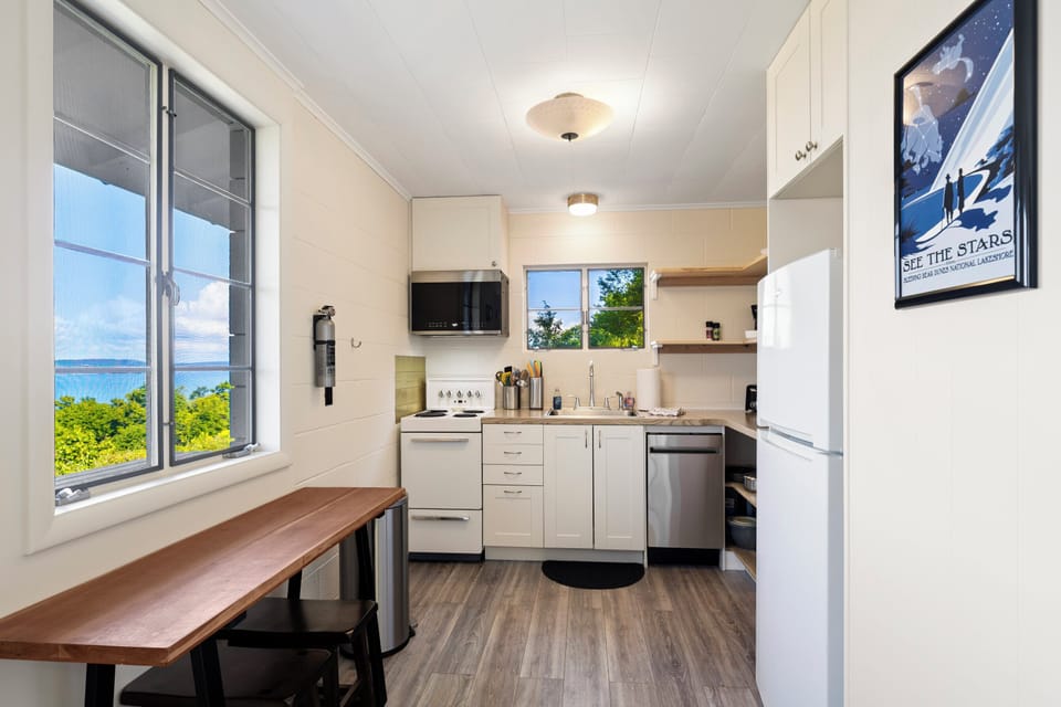 Small and mighty kitchen equipped with modern appliances and a dishwasher.