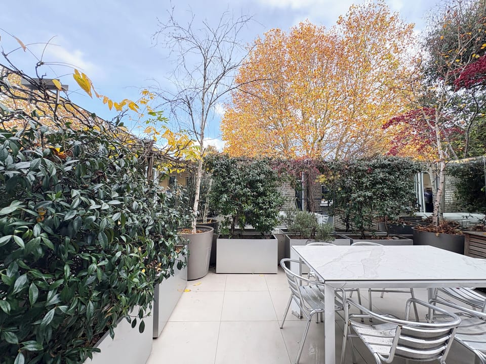 Garden dining table seating up to 8 guests, ideal for al fresco meals. 