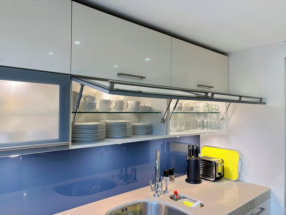 Well stocked with plates and glassware, ideal for entertaining.
