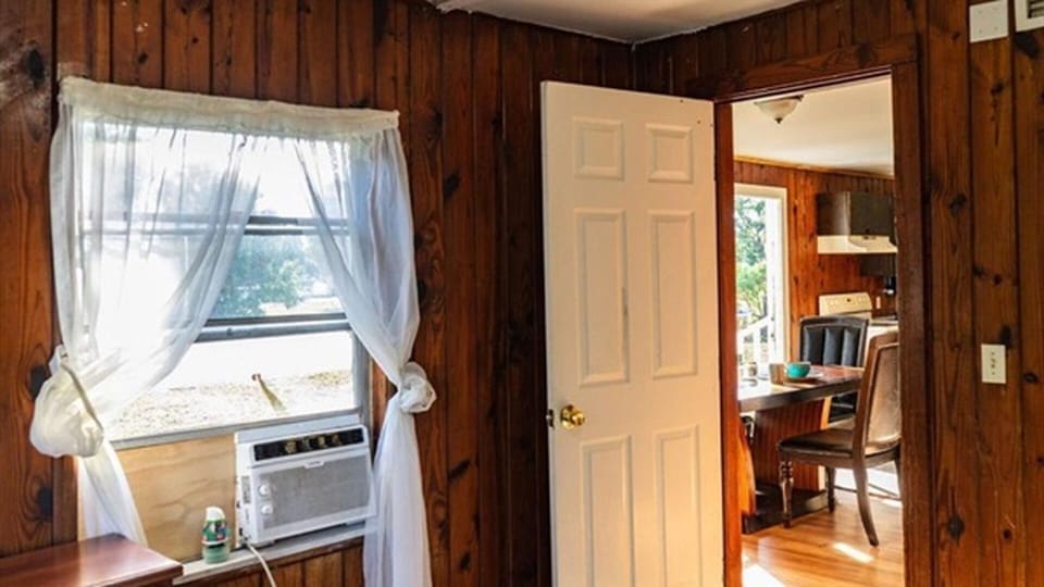 Bedroom with window AC and access to dining area