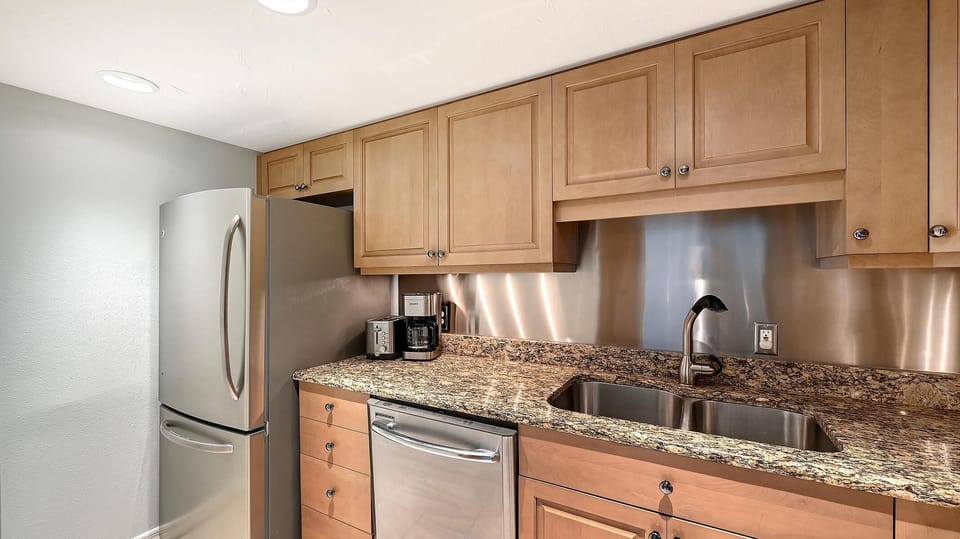 Cozy kitchen with granite countertops and stainless steel appliances
