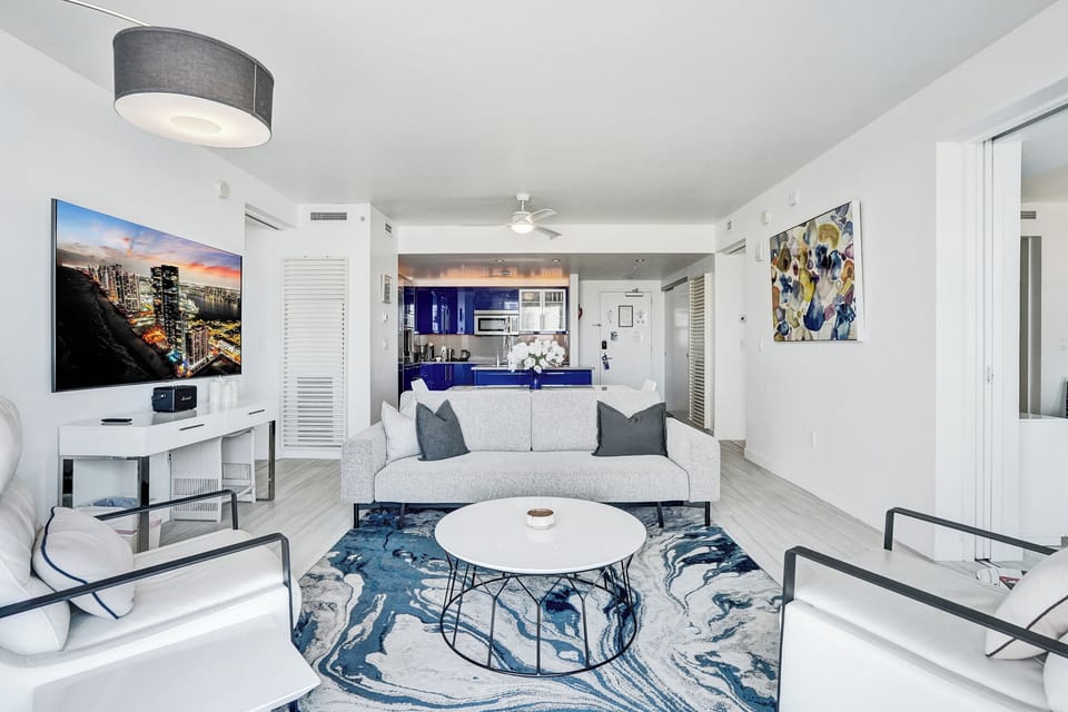 Lounge chairs, sofa and Smart TV for movie nights in the living room.