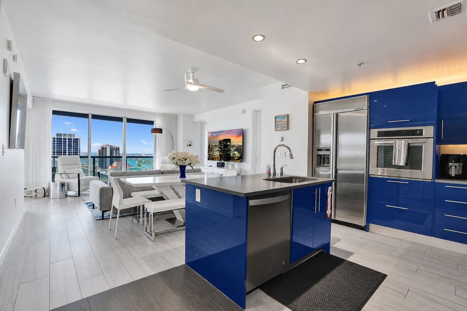 Sleek blue kitchen with island, perfect for cooking together.