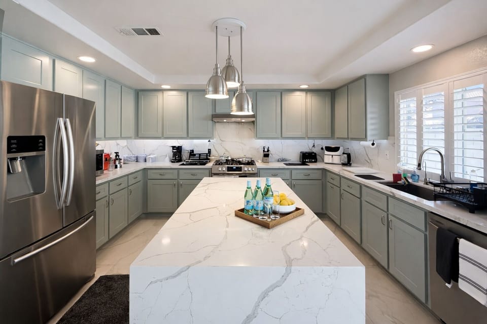 Chef's kitchen featuring dual quartz islands, stainless steel appliances, etc