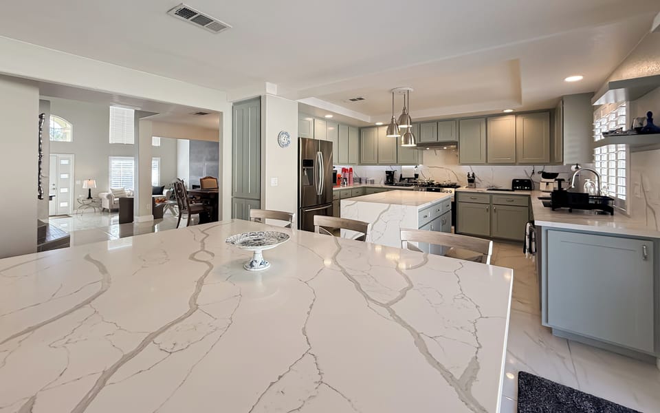 Chef's kitchen featuring dual quartz islands, generous counter space, and etc.