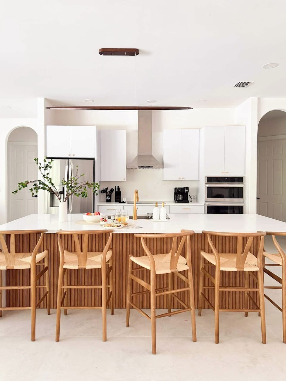 Fully stocked contemporary kitchen with a five-burner electric cooktop.
Pull up to the island to chat, sip, or snack while cooking—it’s where meals and memories happen!