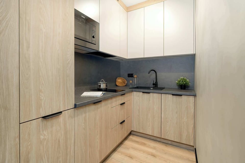 Warm kitchen interior featuring wooden cabinetry and a compact layout.
