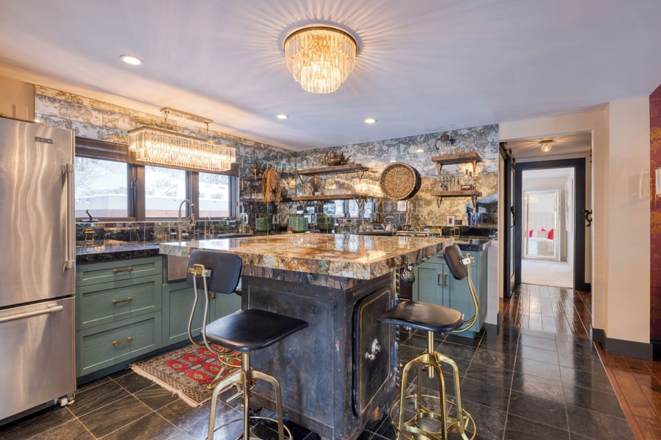 Modern kitchen with a center island table and barstool.