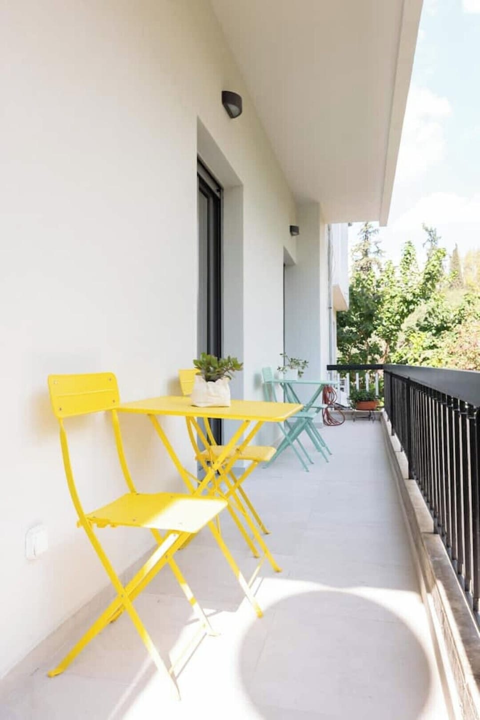 Enjoy morning sun on a calm, green pedestrian street, perfect for coffee outside