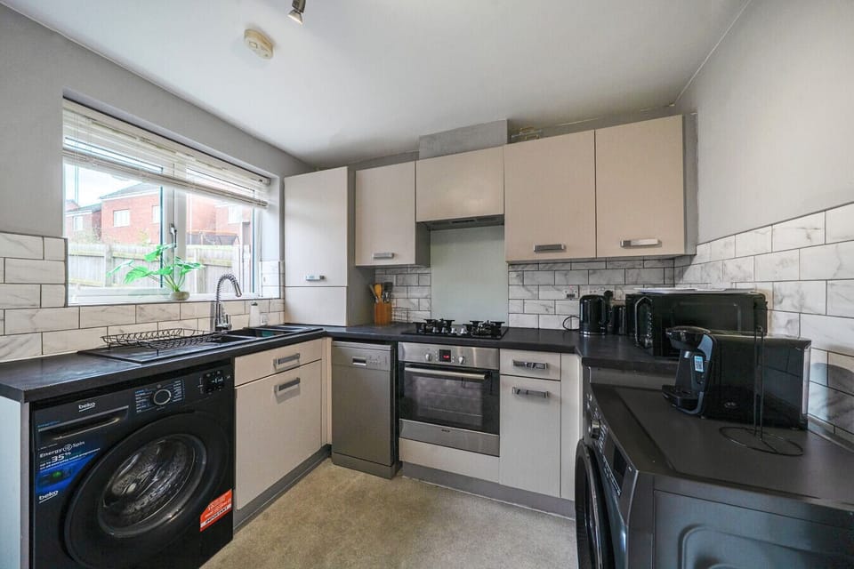 Alternative kitchen view showing additional worktop space and the cooking area.