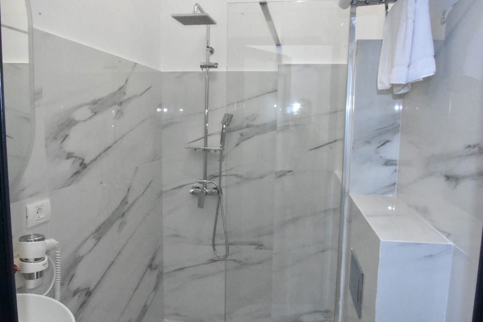 Shower, eco-friendly toiletries, hair dryer, towels